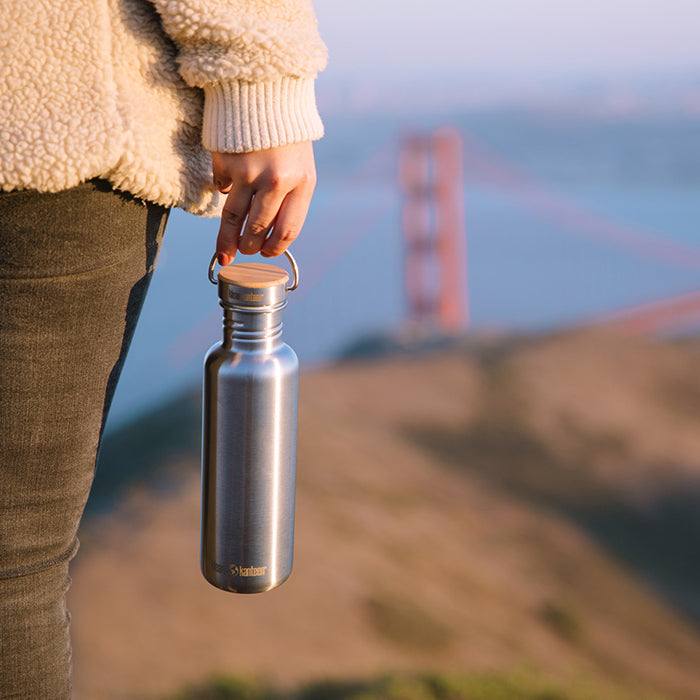 27oz-reflect-with-bamboo-cap-s5 K27SSLRF-BS-BAMBOO_reflect_bottle_bridge_lifestyle.jpg